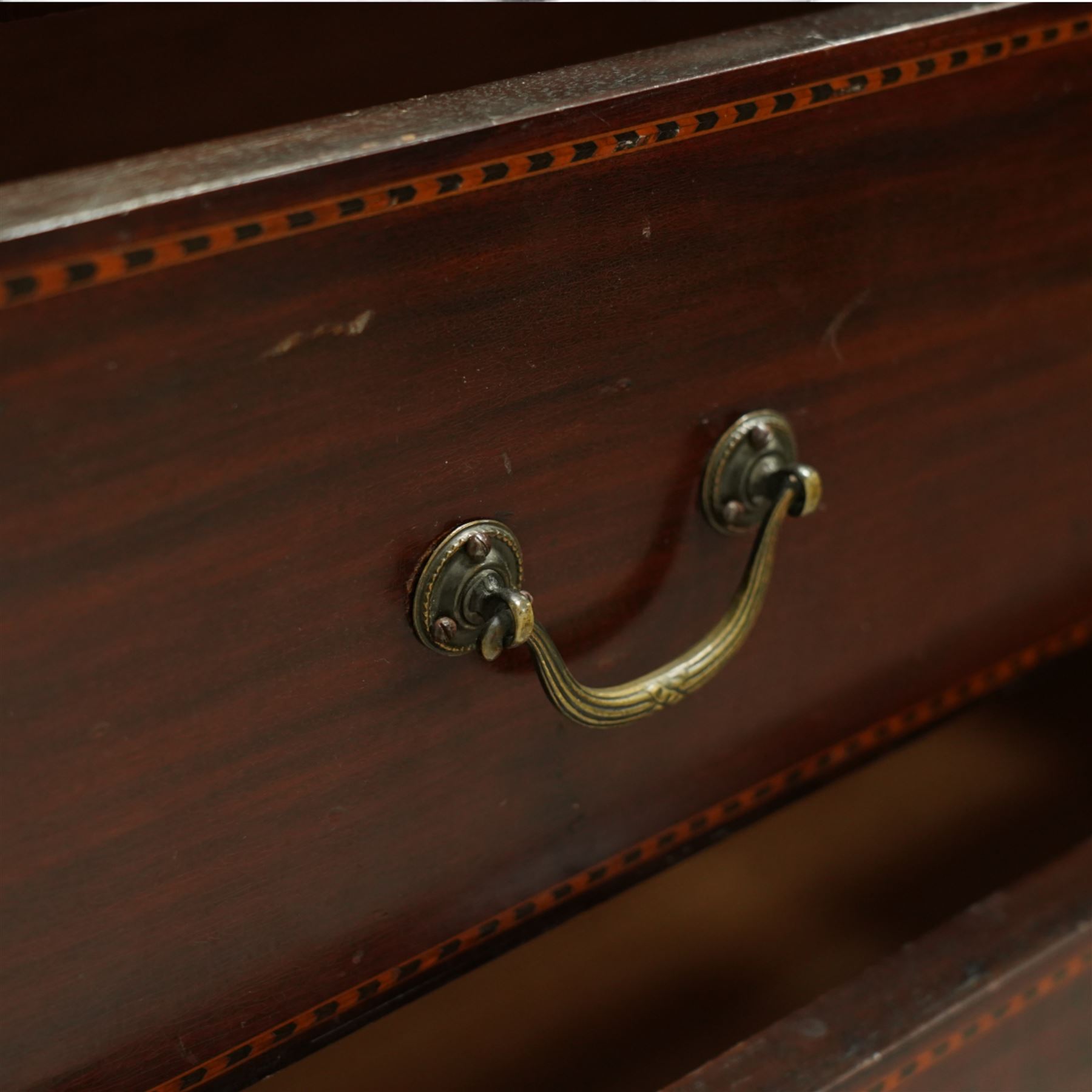 Edwardian mahogany herring-bone inlaid dressing chest, with swivel bevelled dressing mirror, supports with finials, and trinket drawer above chest with three graduated drawers on bracket feet