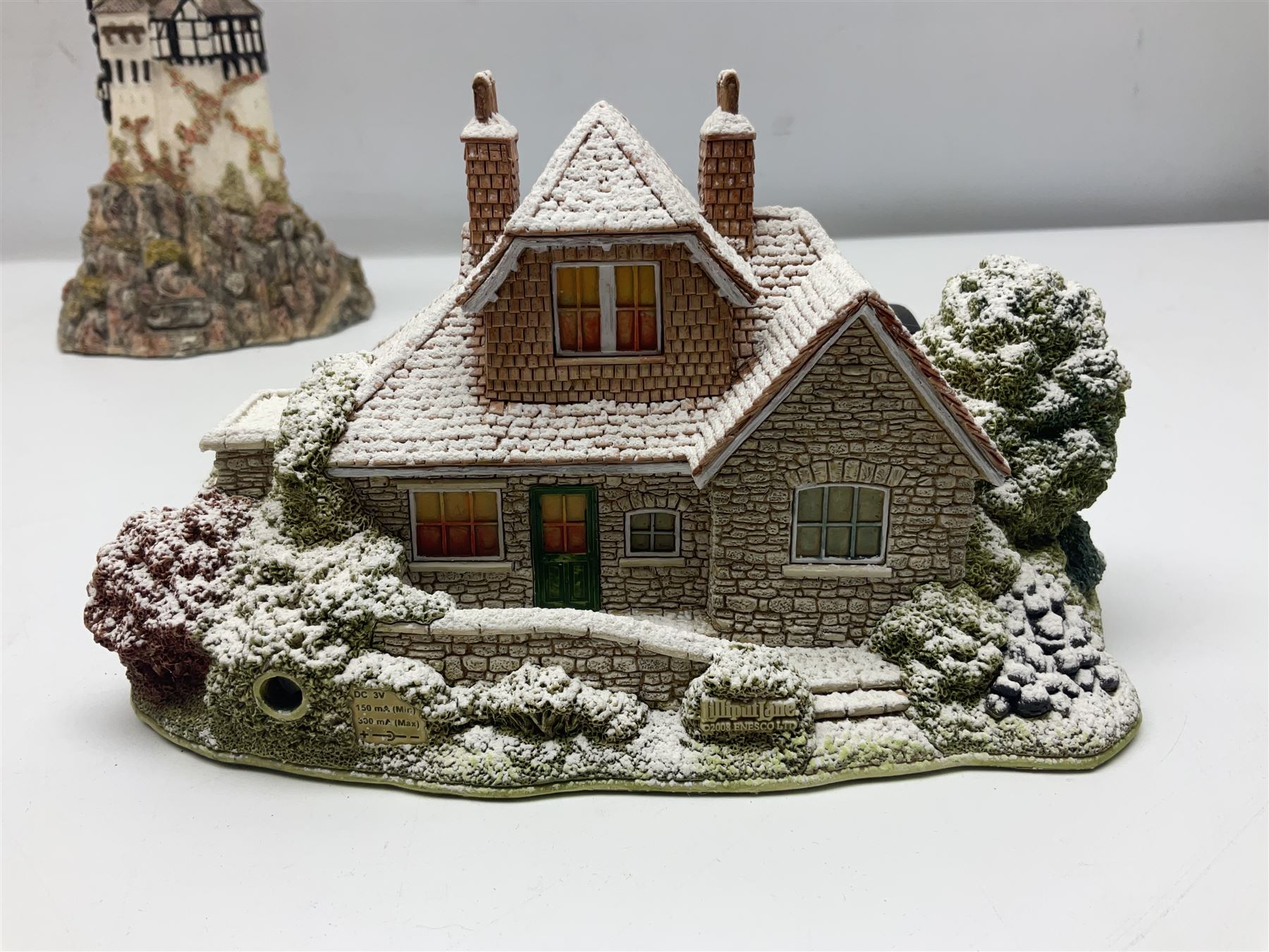 Five Lilliput Lanes, comprising Christmas at Woody Bay Station and Calling Home for Christmas both from the Illuminated collection, Castle of the Exiled Prince, Castle of The Ransomed King and Helvellyn, all with original boxes (5)