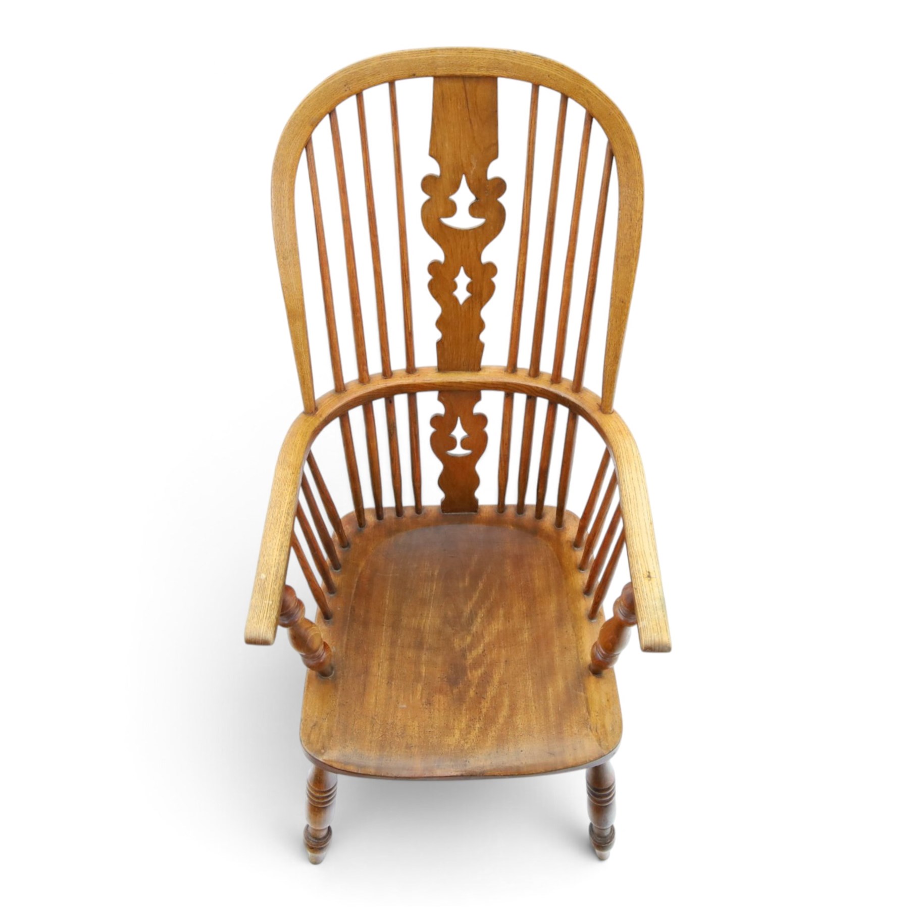 19th century elm Windsor armchair, with central pierced splat, flanked by spindles, dished seat, raised on turned supports united by H-stretcher