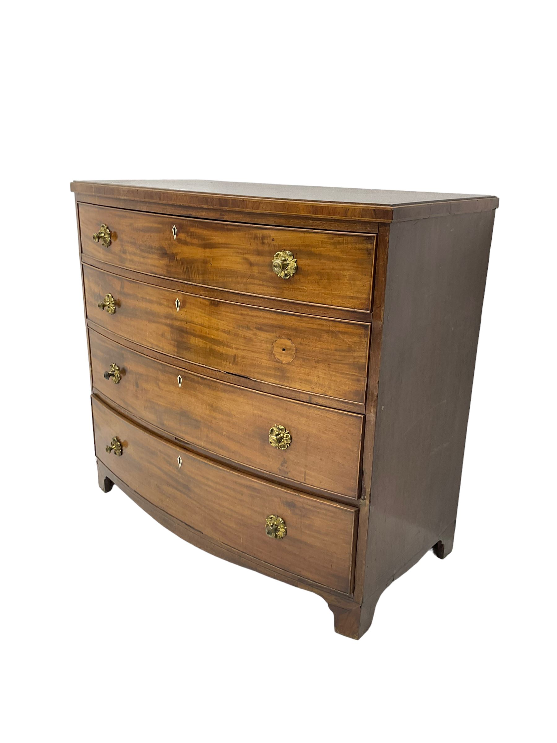 Regency mahogany bow front chest, the top with ebony and satinwood stringing, fitted with four cockbeaded drawers with brass pull handles and bone escutcheons, on bracket feet