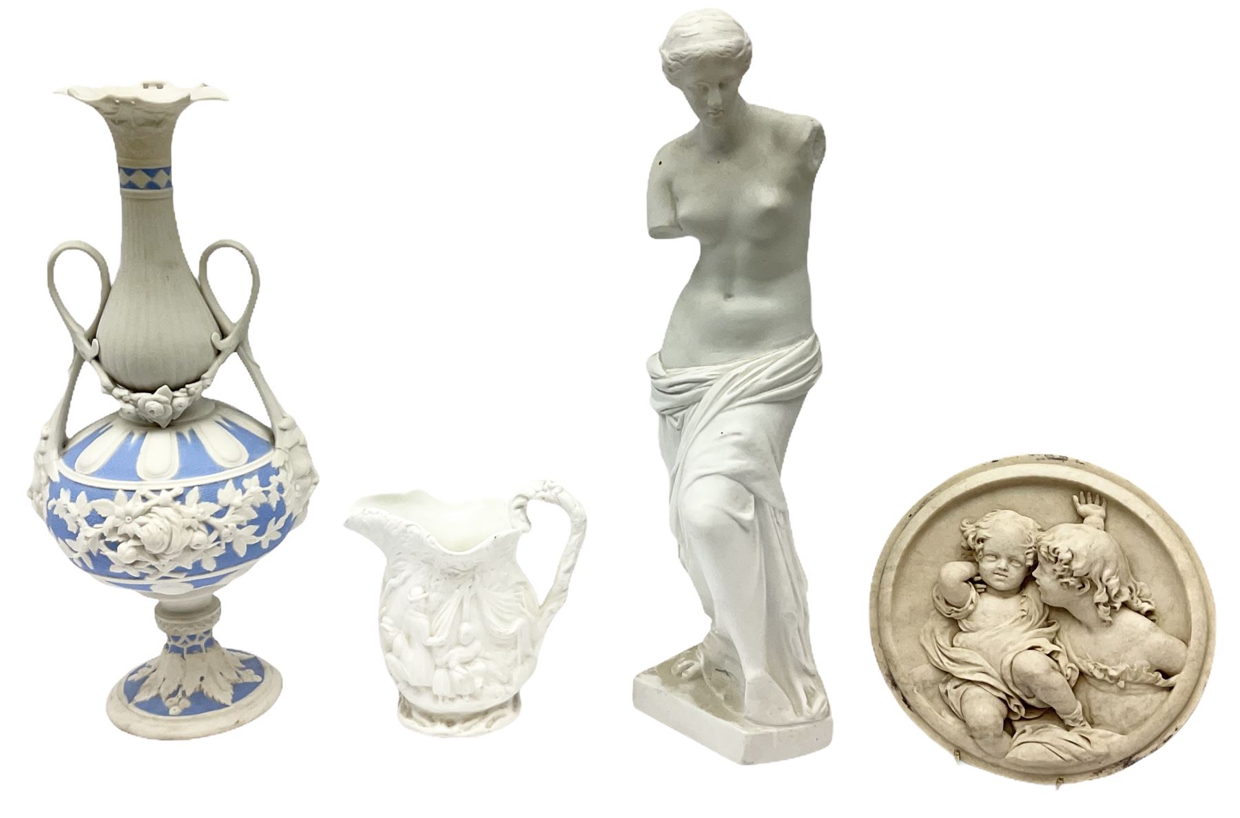 Victorian Parian ware twin handled vase detailed with Bacus masks fruiting vines and floral sprays H36cm, together with a Parian jug H14.5cm, classical Parian sculpture H40cm, decorative plaque decorated in high relief depicting two children D18.5cm. 