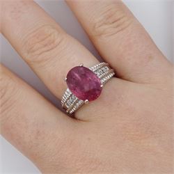 18ct white gold ruby and diamond ring, single oval cut ruby of approx 5.05 carat, with three round brilliant cut diamonds to each shoulder, Birmingham 2006