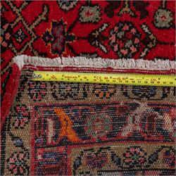 North West Persian runner, the red field decorated with an all-over Herati pattern of diamond lattice motifs, rosettes and serrated leaves, ivory floral spandrels, enclosed by an indigo palmette border and narrow floral guard bands