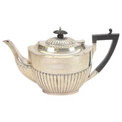 Early 20th century four piece silver tea service, comprising teapot, hot water pot, open sucrier and milk jug, all of oval part fluted form, the teapot and hot water pot with Bakelite type handles and finials, hallmarked James Deakin & Sons (John & William F Deakin), Sheffield 1918
