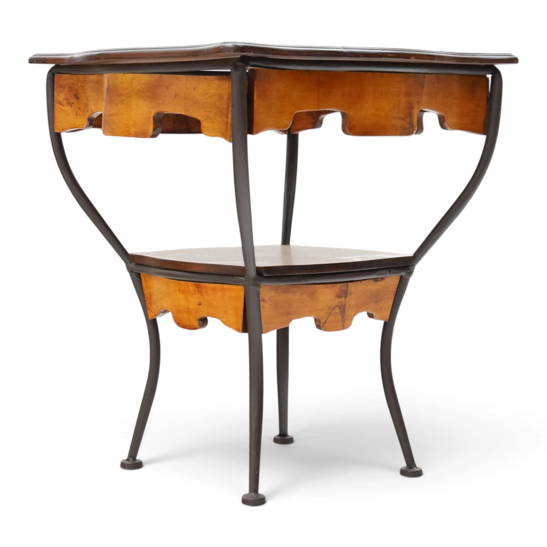 Art Nouveau style occasional table, serpentine shaped top with dark moulded edge, shaped apron and lower shelf, raised on four curved metal supports