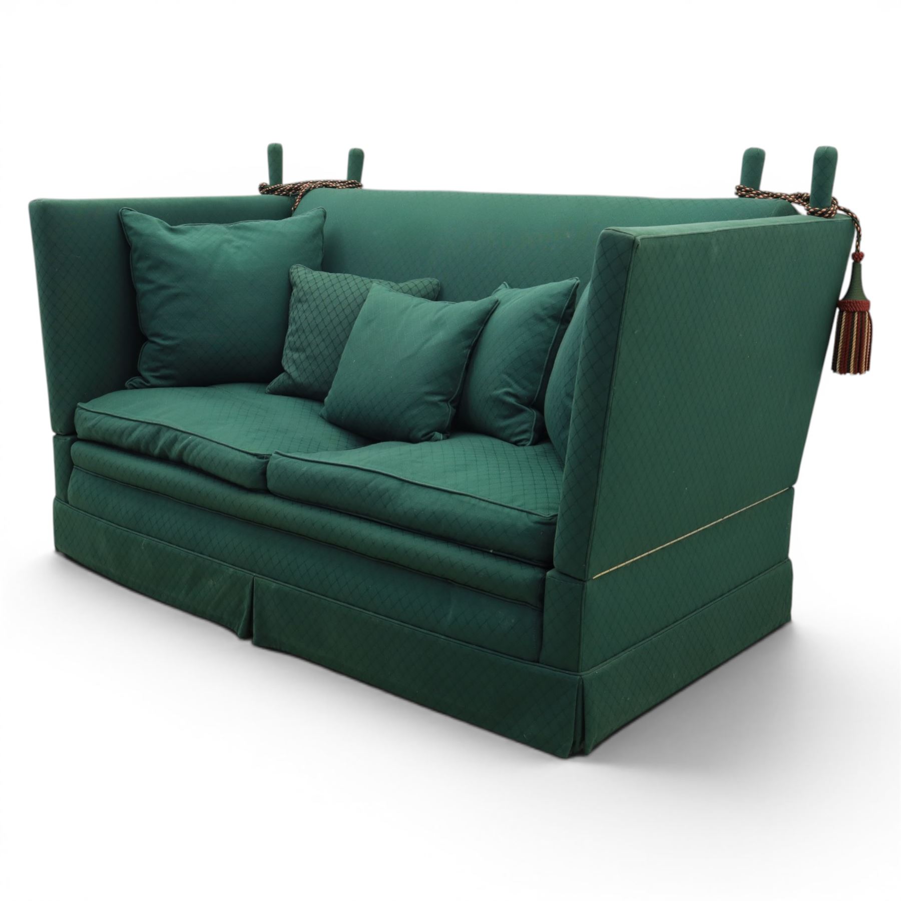Late 20th century two-seat Knole sofa, covered in green woven fabric with lattice pattern, high panelled back and hinged drop arms secured by braided cords, loose cushioned seat and back with additional scatter cushions, on plinth base