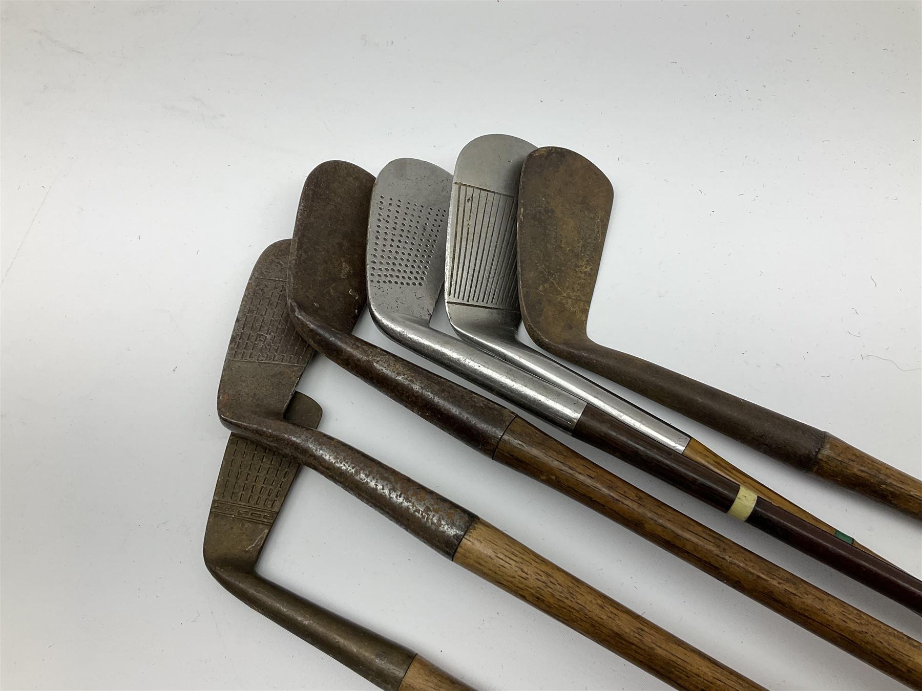 Golf - three early 20th century hickory shafted irons marked R. Simpson, Harrods Ltd etc; child's wooden shafted putter; two transitional wood grain steel shafted irons, one marked Tom Morris; and set of four Macgregor Tommy Armour woods (10)