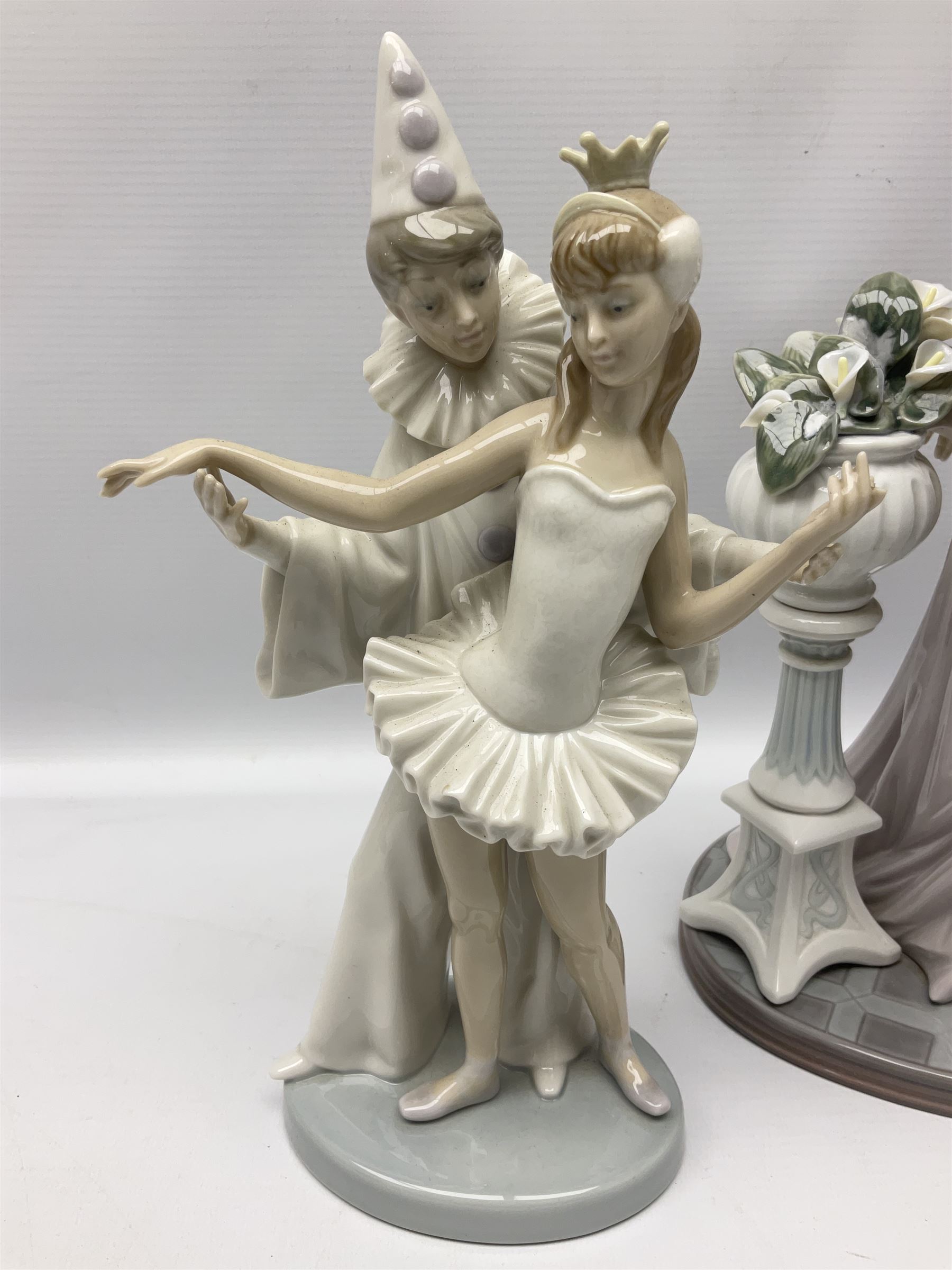 Four Lladro figures, comprising Touch of Class no 5377, Boy Student no 4517, Ocean Beauty no 5785 and Carnival Couple no 4882, largest example H45cm