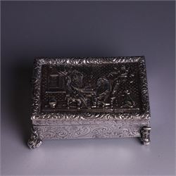 Victorian silver tobacco box, rectangular form, hinged lid embossed with a gaming scene, the body engraved with scrolls and flowers, upon four scrolling mask feet, hallmarked George Heath London 1885, H4.5cm, W10.5cm