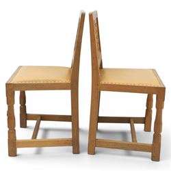 Mouseman - set of four oak lattice back chairs with tan seat with brass studded trim, with carved mouse signature, by the workshop of Robert Thompson of Kilburn