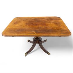 George IV mahogany breakfast table, rectangular tilt-top with reeded edge, rounded corners, supported on a turned column and raised on a quadripartite base with reeded down-swept legs terminating in brass cap castors