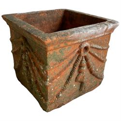 Pair of early 20th century terracotta garden planters, square form with rounded lipped rim, decorated with rope and tassels