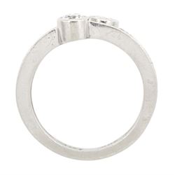 Platinum bezel set, two stone round brilliant cut diamond, crossover ring, London 1985, total diamond weight approx 0.50 carat