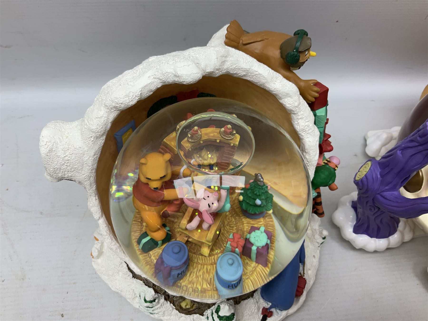 Six Disney Winnie the Pooh Christmas snow globes, comprising large Mr Christmas Holiday Snowfall, An Enchanted Christmas, It's A Small World Christmas 1994,  Tree Trimming, 1995 Christmas At Our House and Christmas Band Concert, together with Mr Christmas Holiday Go Round, all with boxes (7)