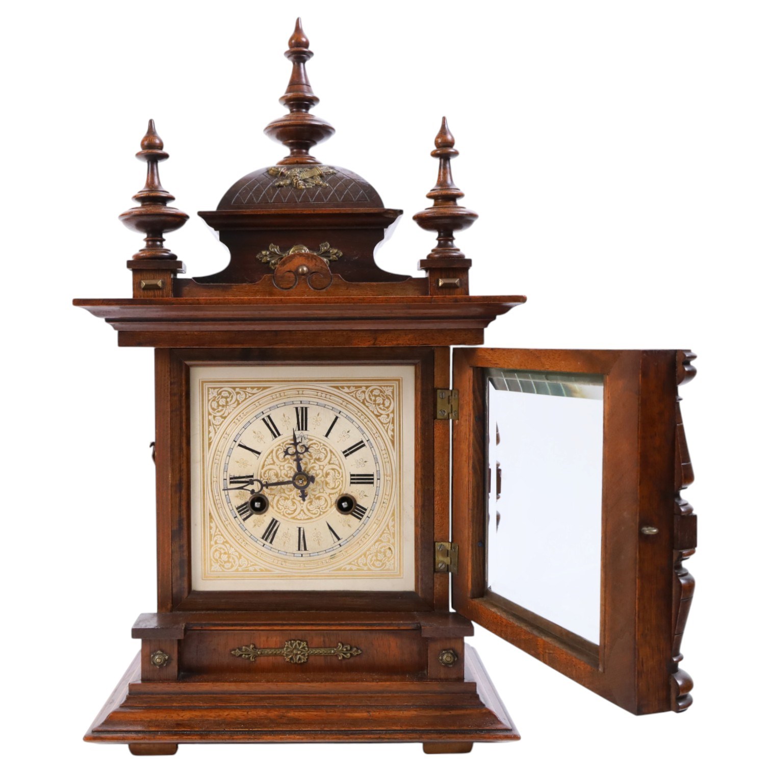 Junhgans eight-day cased mantle clock, with a square etched dial and Roman Numerals, a carved ogee pediment and turned finials, on a broad blinth with bun feet, H49cm