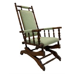 Early 20th century walnut framed American rocking chair, upholstered seat, back and arms