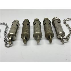 Three Hull City Police 'Metropolitan' whistles by J. Hudson 13 Barr Street Birminham, each with impressed collar number; another 'Metropolitan' police whistle with chain; and an ARP whistle by Hudson & Co with chain (5)