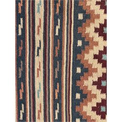 Flatweave rug, terracotta ground with multicoloured geometric diamond motifs, framed by a teal and burgundy border, finished with fringed edges
