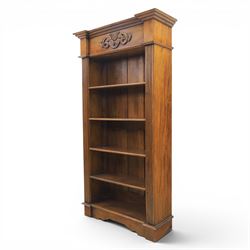 Hardwood open bookcase, fitted with five open shelves, applied carving to top facia