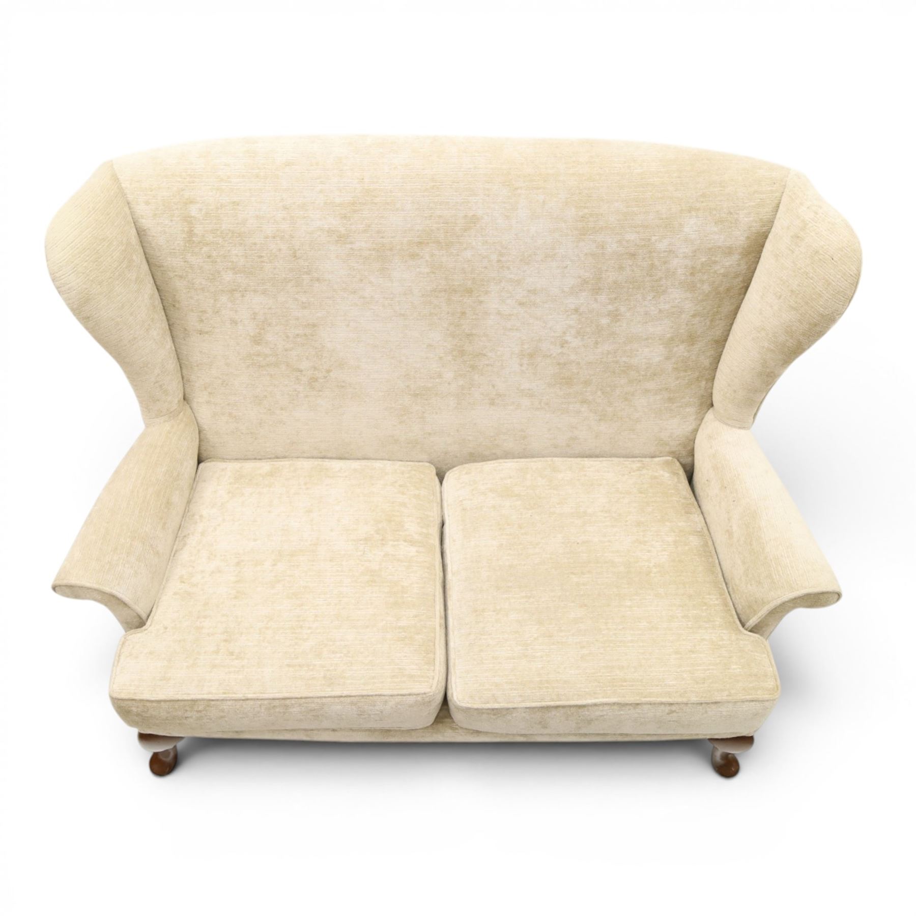 Parker Knoll - 'Hartley' lounge suite, comprising three wingback armchairs and two-seat settee, upholstered in cream fabric, shaped wing backs with scroll-over arms and loose seat cushions, on cabriole supports with pad feet wingbacks and settee

Armchairs: H 96cm, D 83cm, W 75cm