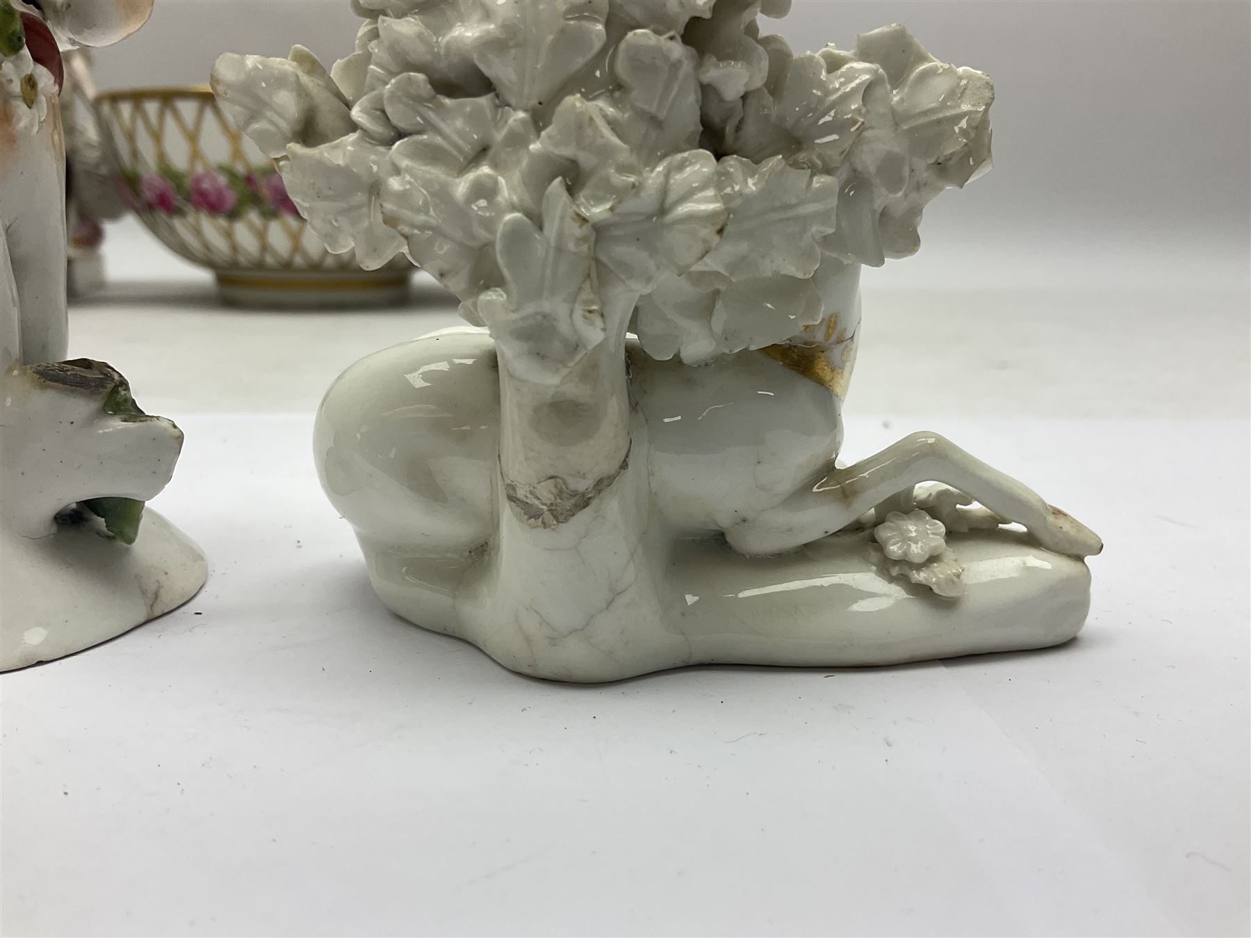 Group of 18th and 19th century ceramics for repair and restoration, to include an 18th century Derby figure emblematic of the Continent of Africa, pair of small 19th century Derby vases, painted with birds and floral spray, 19th century Derby slop bowl decorated in the 594 pattern with pink roses against gilt trellis, 19th century Derby figure of a recumbent deer, Serves style box, and two further figures