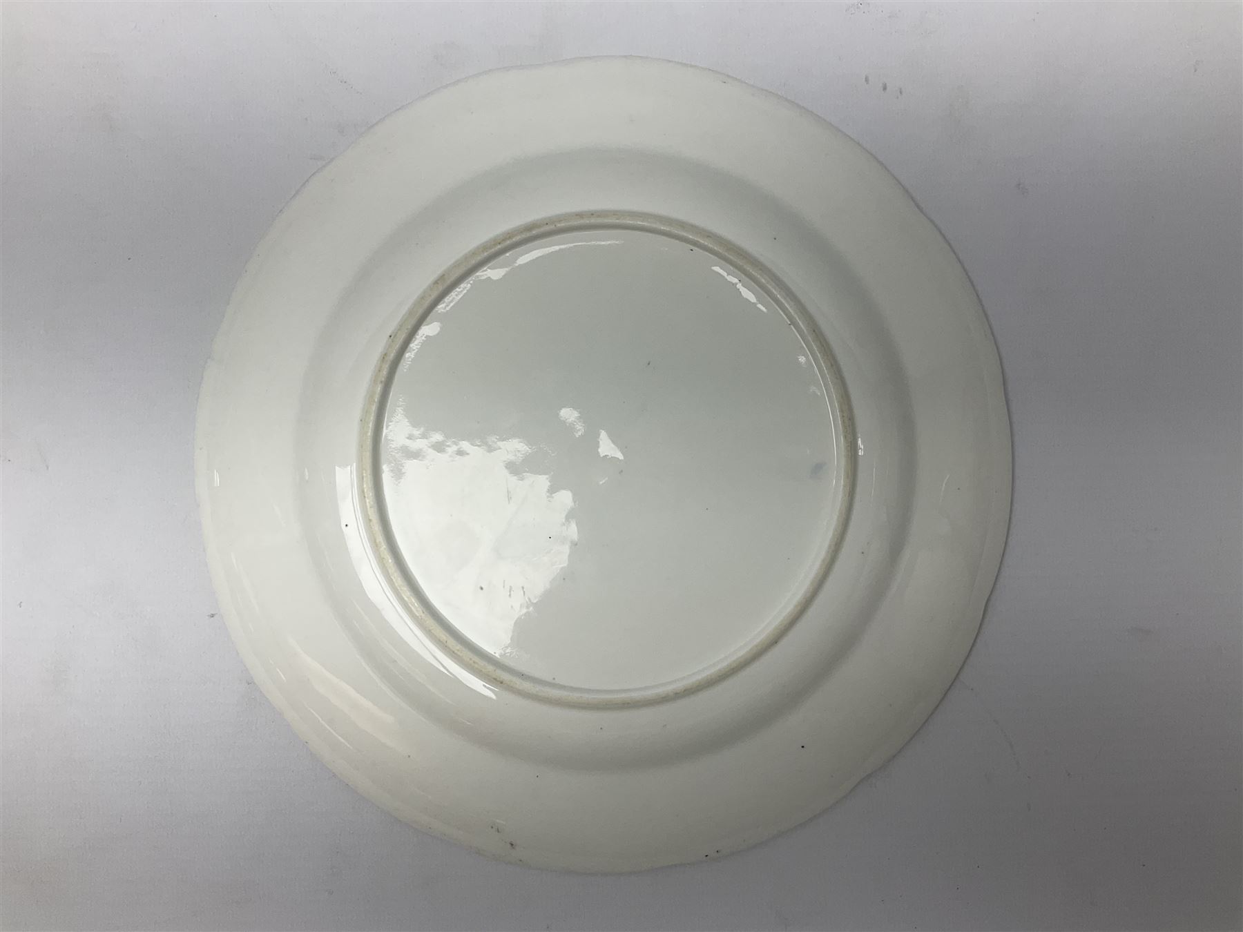 Three 19th century plates, comprising two circular examples and one oblong, each with osier moulded sides, the centres decorated in underglaze blue with Gillyflower type pattern, circular examples D25cm oblong example W27cm