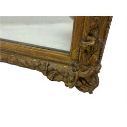 19th century gilt framed wall mirror, the corners decorated with flower heads with extending foliage, plain mirror plate
