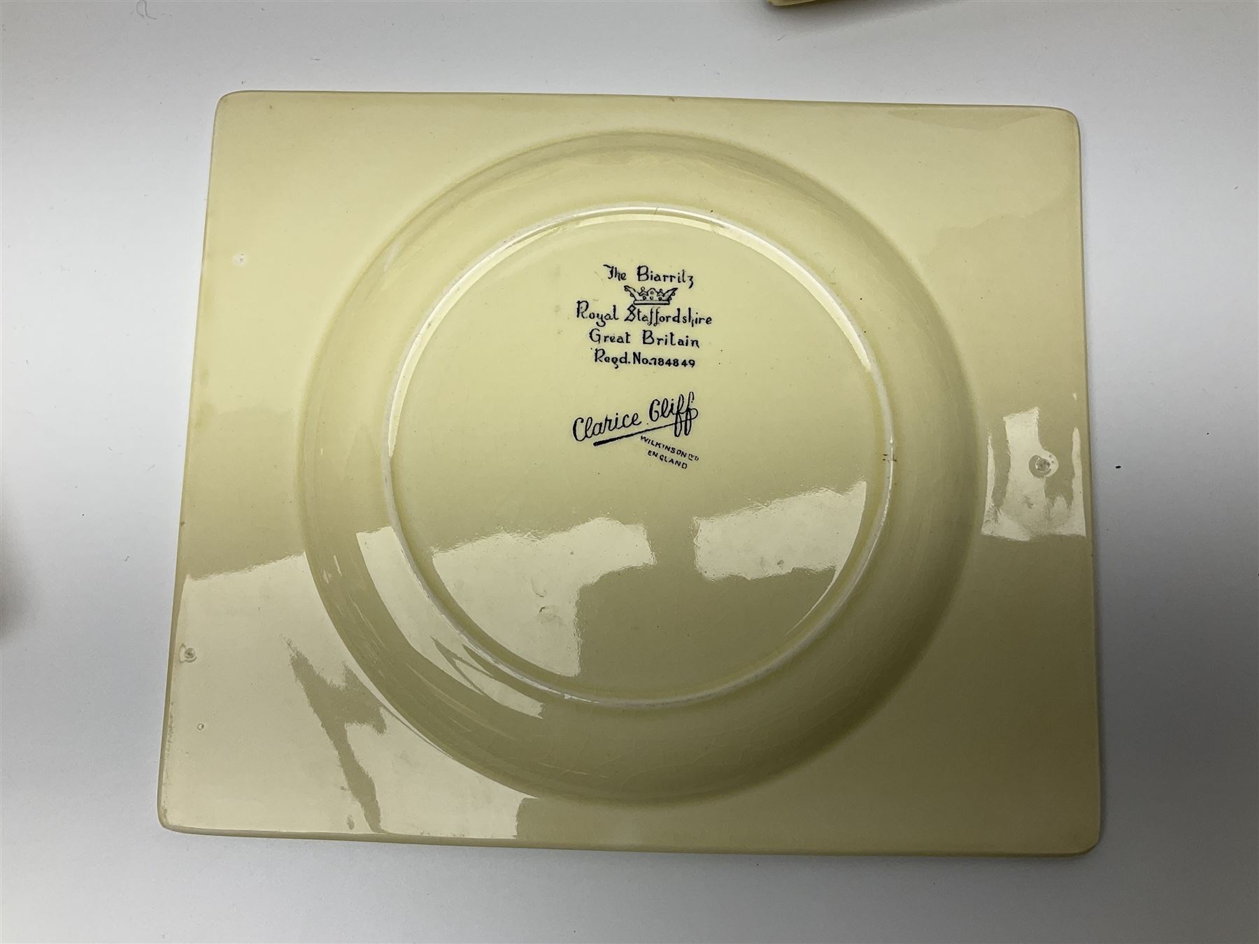 Clarice Cliff Biarritz part dinner set, circa 1930, for Royal Staffordshire, of rectangular form, decorated with bluebells, to include one serving plate, six dinner plates, three side plates, etc, printed mark beneath with reg no 784849 (17)