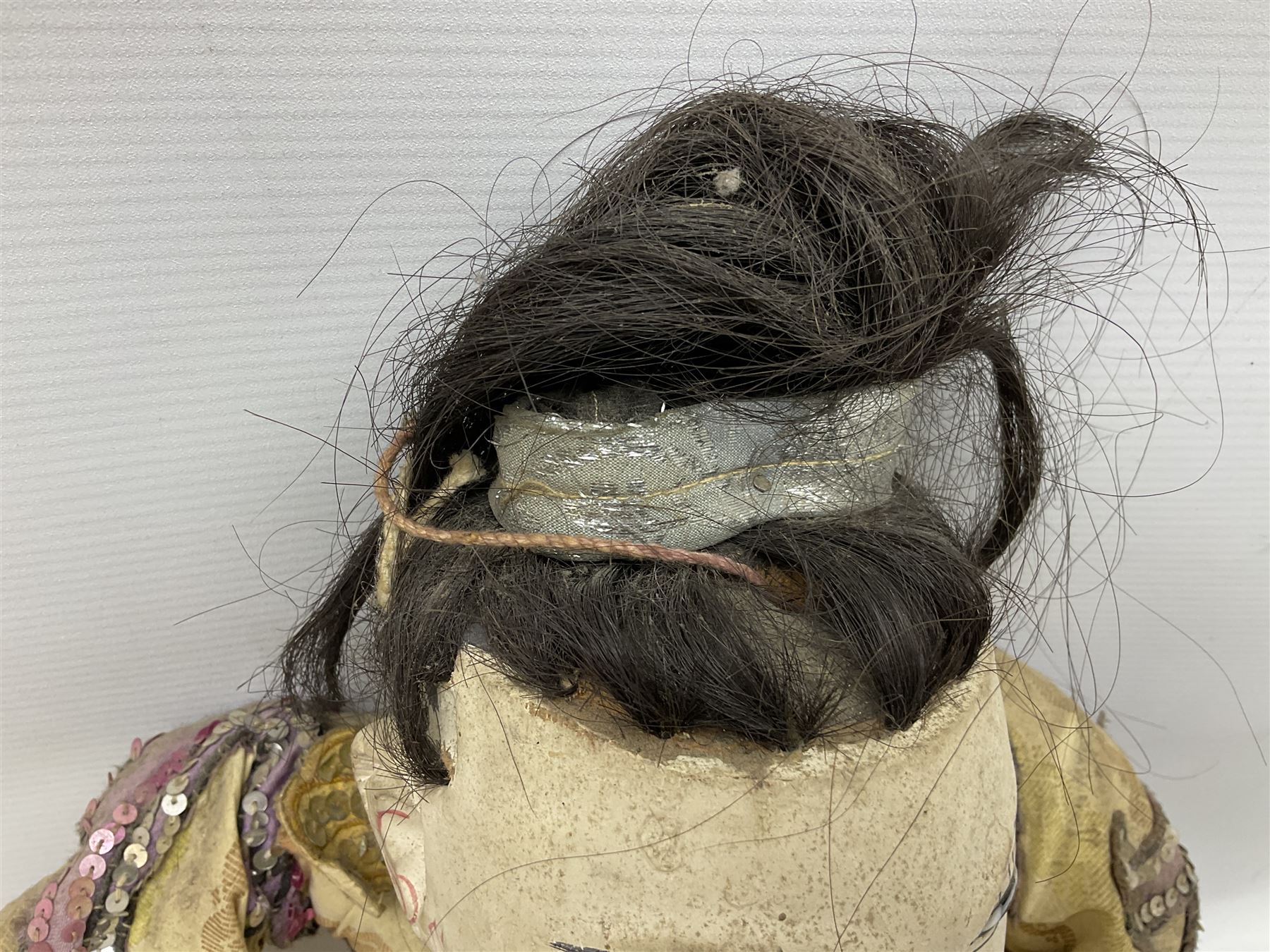 Large string puppet, probably Thai or Burmese, modelled as a woman in traditional costume embellished with sequins, the painted head with articulated mouth, the wood body and hands jointed, L70cm