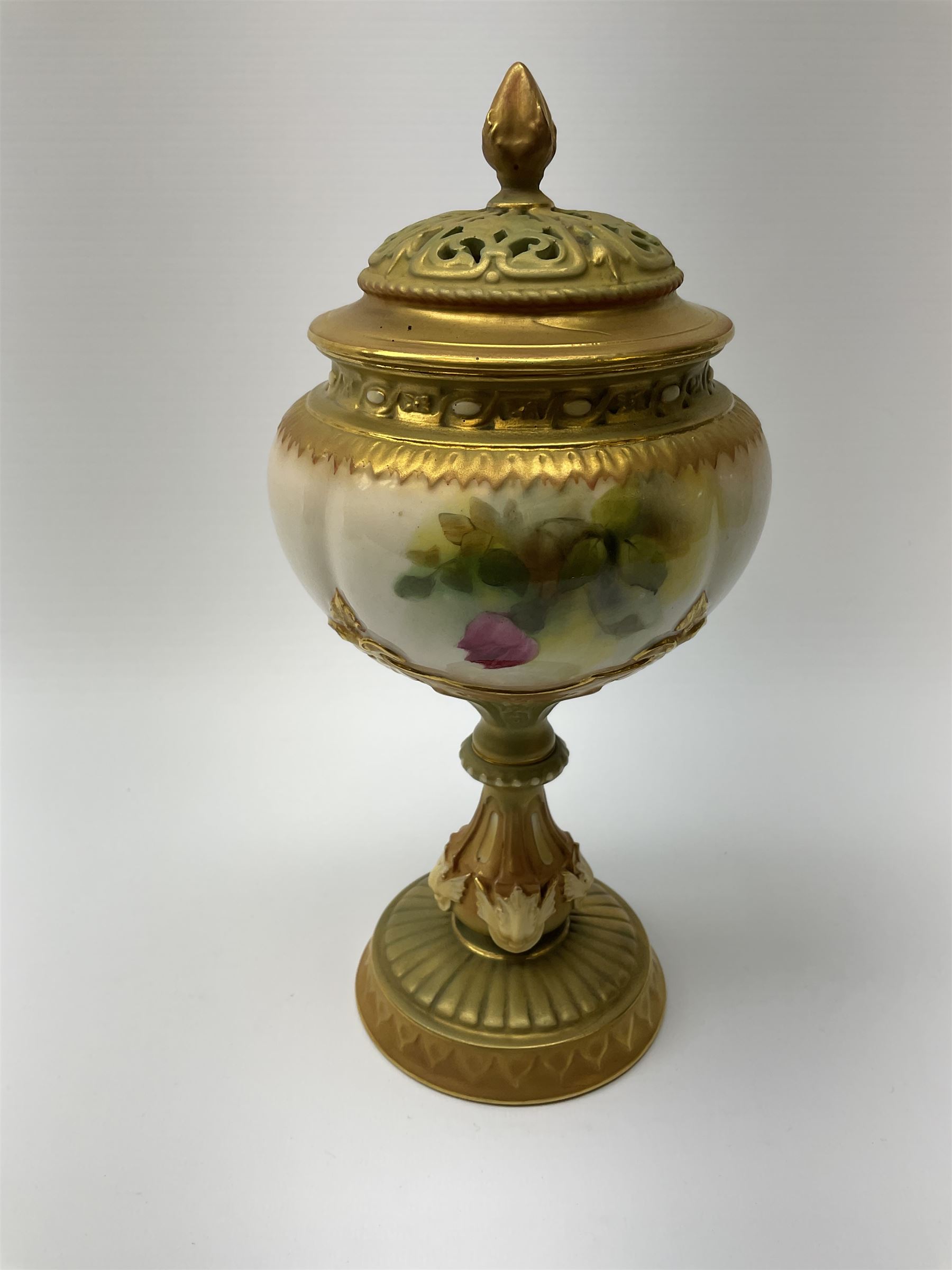 A Royal Worcester potpourri vase and cover, shape 1813, the bulbous body hand painted with pink roses and signed A Watkins, supporting a gilded and burnished pierced cover, upon a moulded stem with zoomorphic mask detail and circular foot, with puce printed mark beneath, H24cm