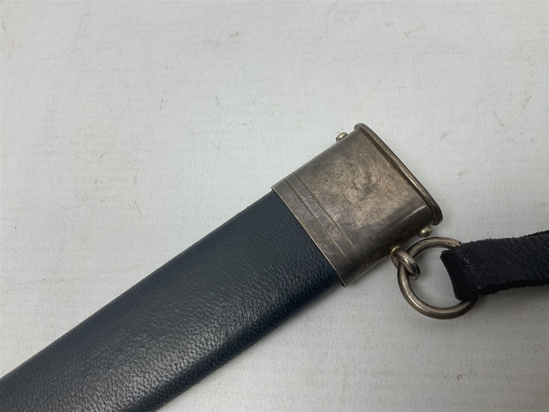 German Paul Weyersberg & Co Solingen DLV flyers dagger with 18cm steel blade, plated brass/tombac downswept cross-piece and pommel and leather covered grip, in leather and plated brass/tombac scabbard with leather hanger strap and silvered knot L35cm overall. Auctioneer's Note: After WWI Germany was forbidden an air force by the Treaty of Versailles however the Deutscher Luftsport-Verband (German Air-sport Association) was formed in March 1933 from various sports flying clubs and had branches for aeroplane, gliding and balloon flying. Under cover of the sporting DLV, many future Luftwaffe pilots trained to fly. DLV was embodied with the NSKK in March 1935 and on 1st March 1937 Luftwaffe was formed.