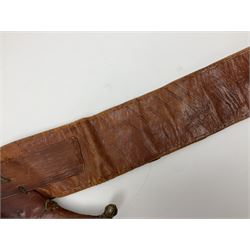 Late 19th century Yemeni Tuza jambiya as worn by religious elite, the 20.5cm curving blade with raised medial ridge, the horn hilt with pique style studwork, in a leather wrapped wooden scabbard with pierced metal mount and leather belt applied with embroidered 'gold' and 'silver' thread work panel; dagger L36cm overall, belt L84cm