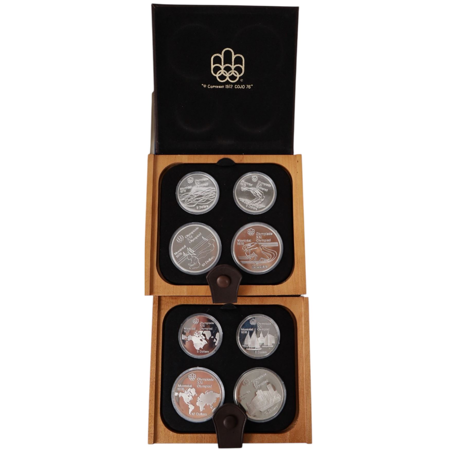 Seven Royal Canadian Mint 1976 'Montreal Olympics' silver proof four coin sets, each containing two five dollar and two ten dollar coins, each cased and boxed with certificates