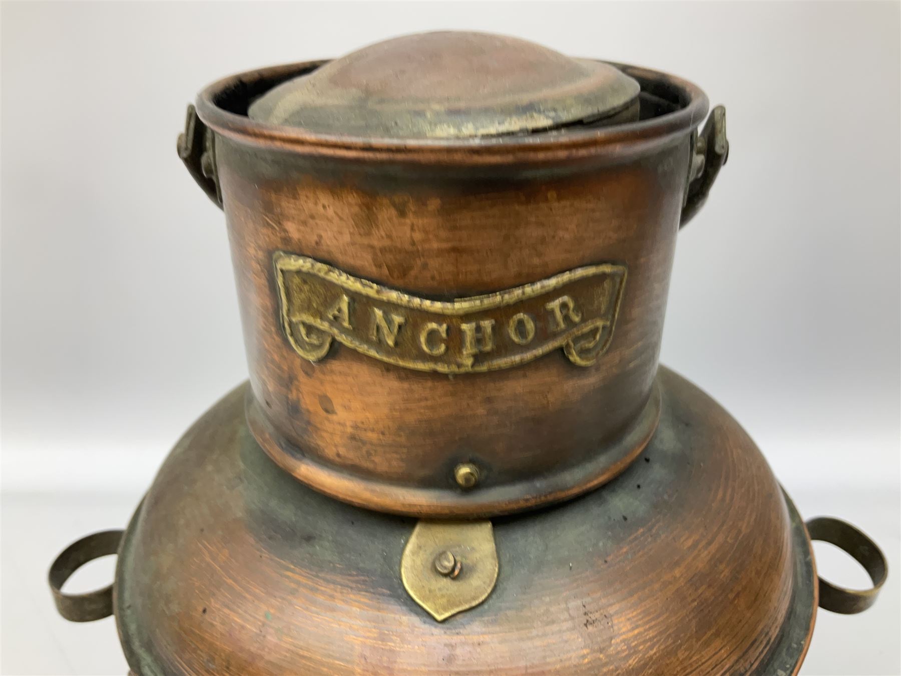 Copper and brass ship’s lamp marked ‘Anchor’, H25cm, Feuer hand storm lantern, Bialaddin Model 315 paraffin lamp and an Anchor lamp (4)