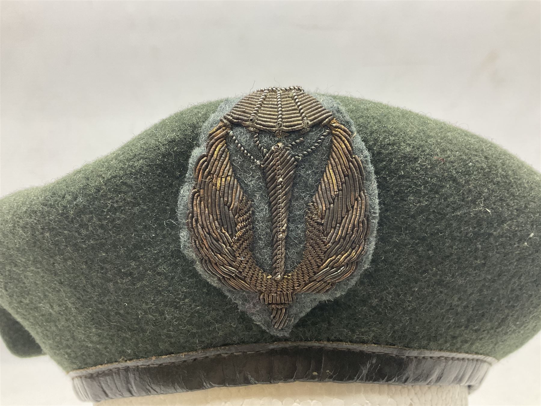Four paratrooper berets - Russian, Italian, British and Foreign Legion; all with badges (4)