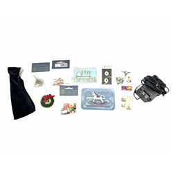 Georgian style wooden double fronted three-storey dolls house with pale blue stucco finish under a faux tiled roof with two chimney stacks, the double hinged front opening to reveal six fully decorated rooms with floor coverings, central staircase, porcelain fitted bathroom, kitchen with deep white sink and Aga cooker, electric lighting with adaptor, fully furnished with French style and other furniture, grand piano etc, and comprehensive range of accessories H82cm W61cm D31cm