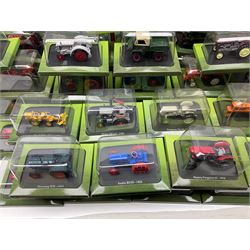 Eighteen issues of Tractors and The World of Farming magazine, together with sixty diecast tractors, all in original packaging, in three boxes 