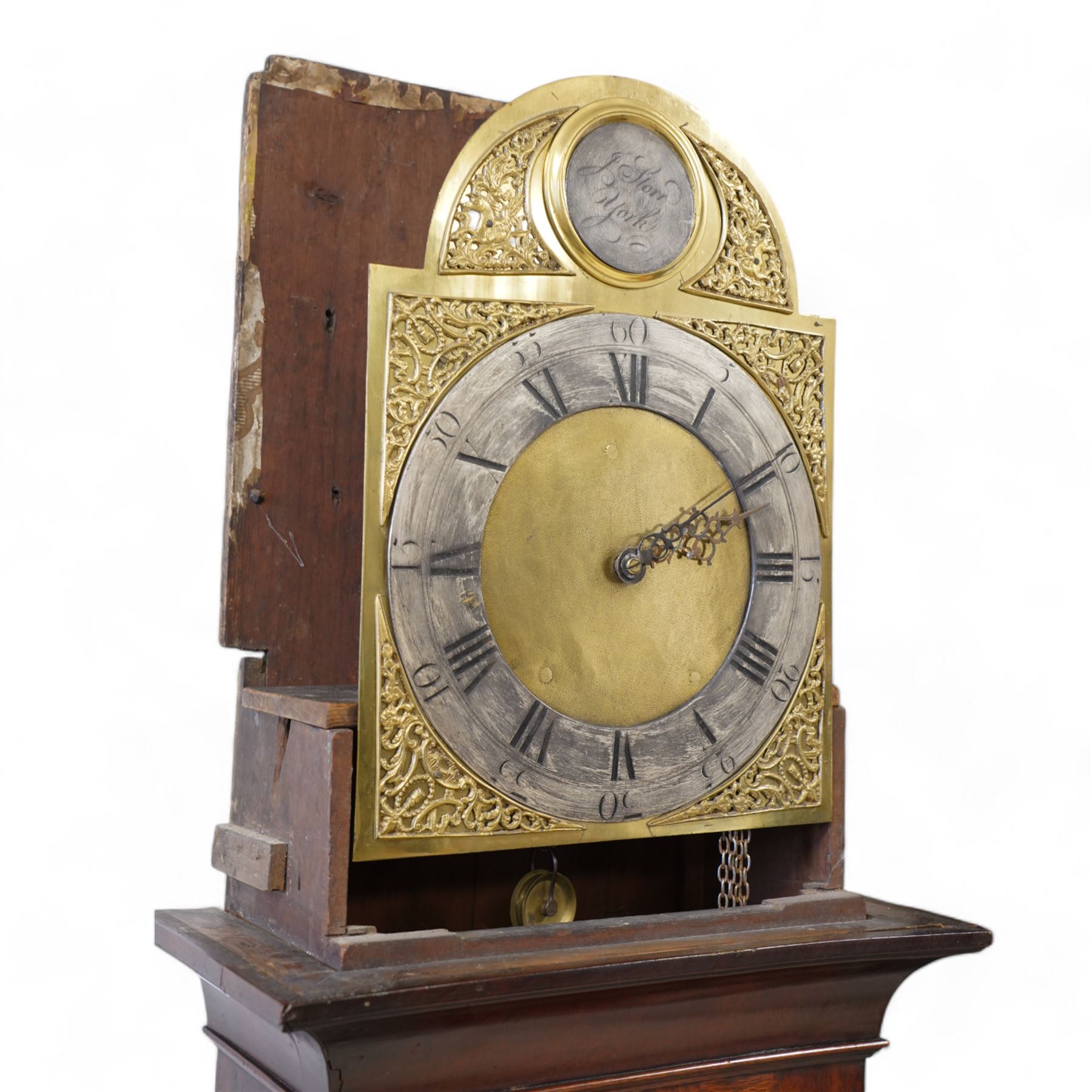 Johnathan Storr of York - 30 hour longcase clock c1770, in a later mahogany case with a decorative swan neck pediment, carved gilded eagle and fretwork, with a dogtooth moulding, break arch hood door and detached pilasters beneath, trunk with a conforming break arch topped door on a square plinth with raised moulding and bracket feet, brass arched dial with makers name to the arch, plain dial centre and silvered chapter ring with Roman numerals, five minute Arabic's, minute track and matching steel hands, chain driven movement with a countwheel strike on a bell. No Pendulum or weight.
Johnathan Storr was an 18th century York clockmaker, working from Petergate and Minster gates in the city centre.