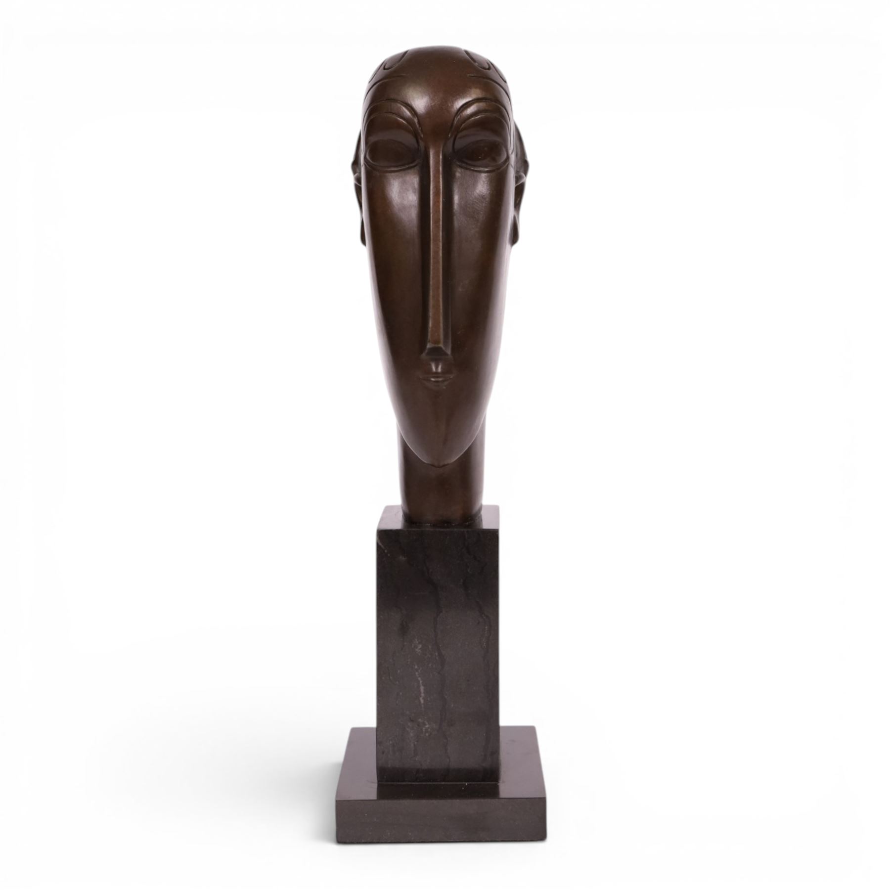 After Amedeo Modigliani - bronze sculpture modeled as a female face, upon a square base, overall H38cm