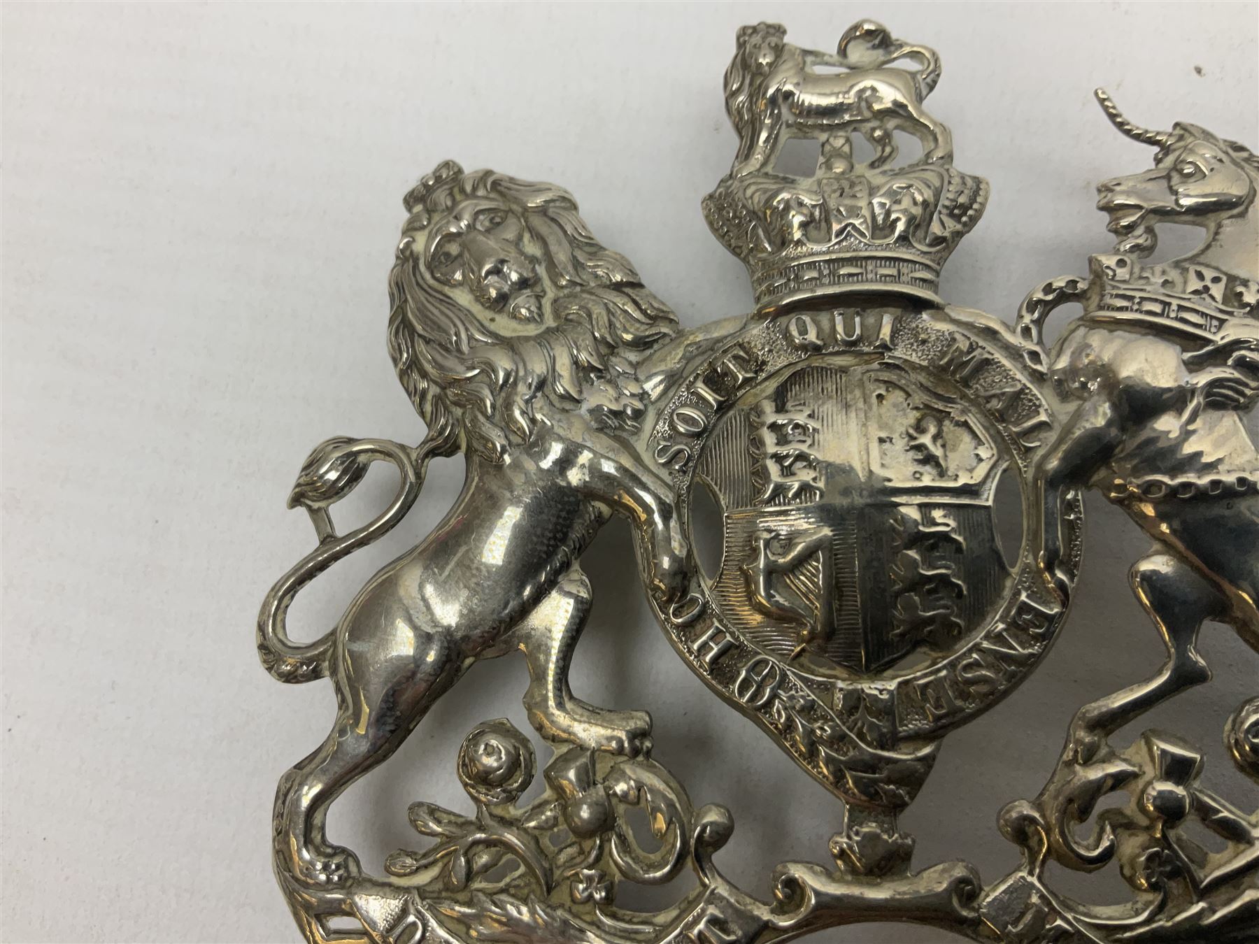 Victorian Volunteer Medical Staff Corps white metal helmet plate in the form of Victorian crowned Royal Arms with three part lower scroll for “VOLUNTEER MEDICAL STAFF CORPS”; three lug fittings to the reverse L8.5cm