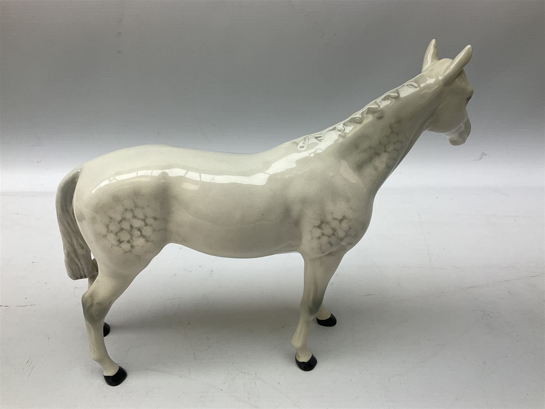 Collection of Beswick horses, including grey horse no.701, palomino foal no 836, grey stocky jogging mare no.855 etc, together two Royal Doulton horses, (8)