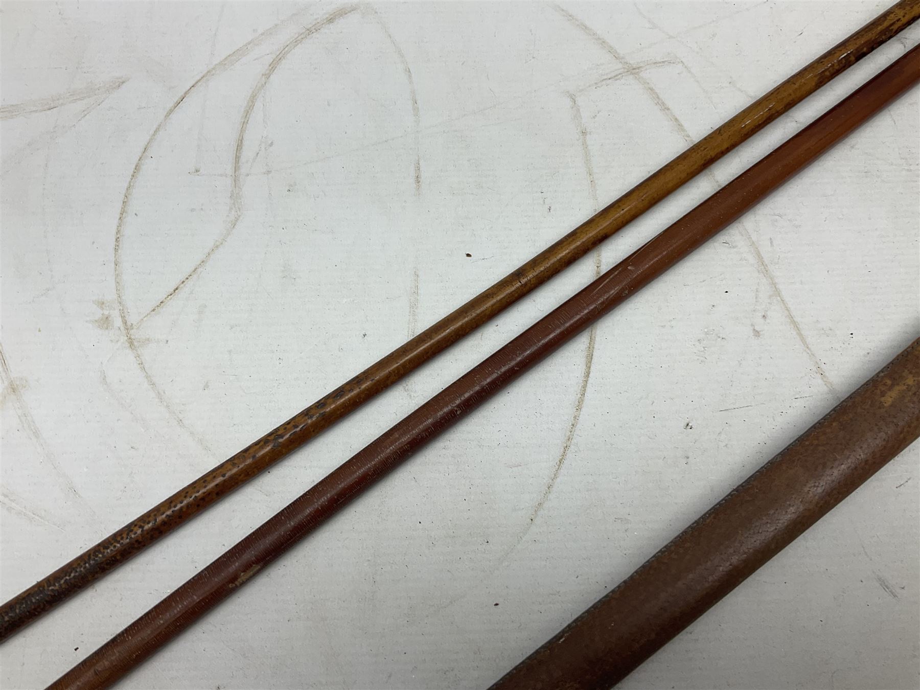 George V 1897 pattern Army Officer's sword by Henry Wilkinson Pall Mall London, the 82.5cm 'London Made' blade etched to both sides with Royal Crests and cyphers etc, pierced half-basket hilt with wire-bound fish skin grip and remains of leather knot strap; in leather covered field service scabbard L101cm overall; and two 14th Prince of Wales Own swagger sticks (3)