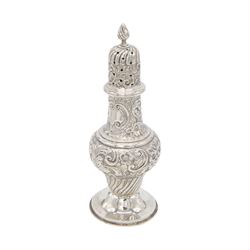 Edwardian silver sugar caster, of typical waisted form profusely embossed with floral and foliate decoration, the removable pierced cover with fluted finial, upon a circular stepped foot, hallmarked William Aitken, Birmingham 1901, H23cm
