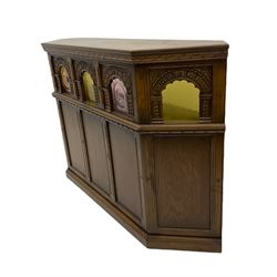 Old Charm - canted oak drinks bar, arched apertures set with mottled and bullseye colour glass panes, and three stools