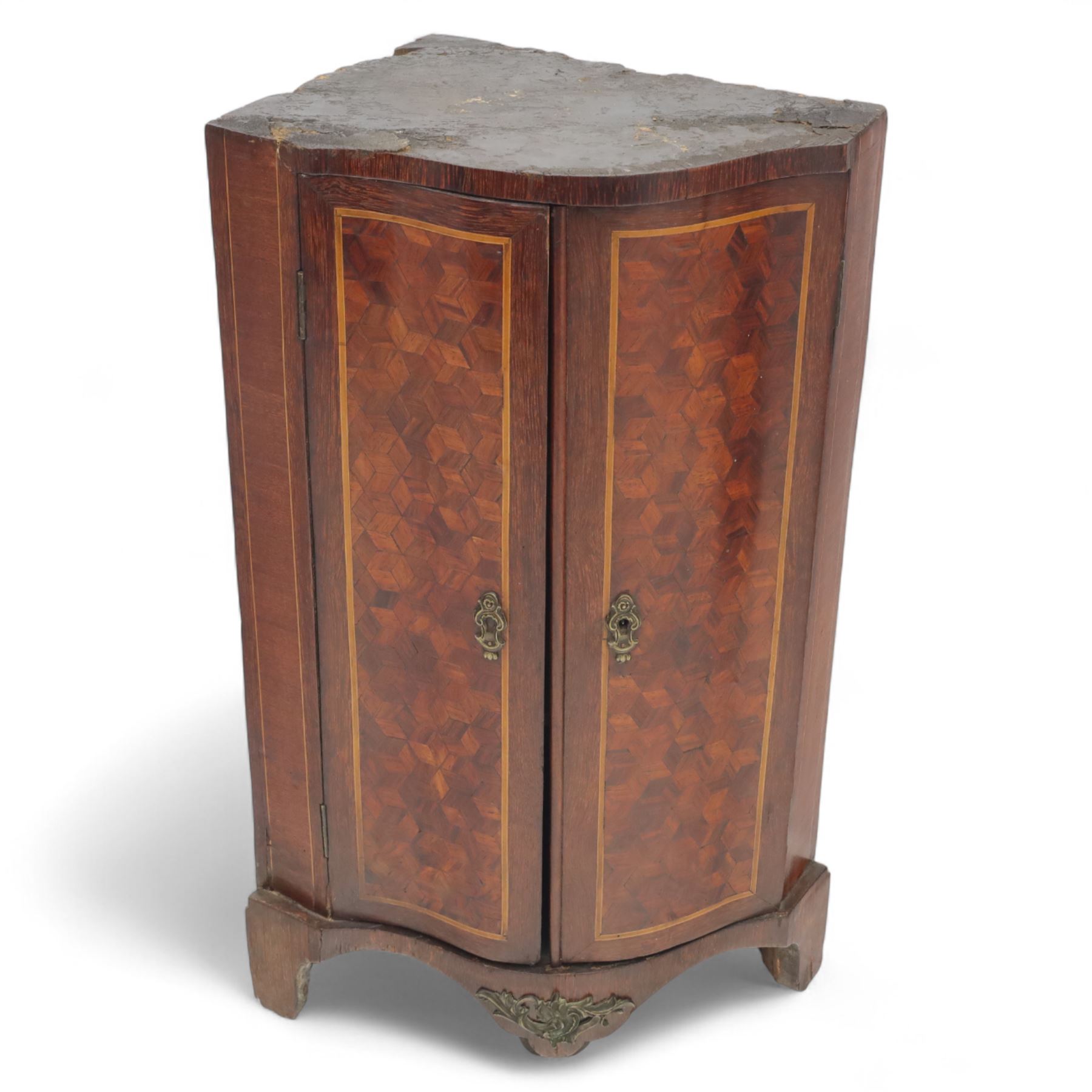Three-piece mixed furniture lot, comprising an Edwardian mahogany occasional table with inlaid border and under-tier (H 70cm, W 54cm, D 38cm), a French parquetry corner cabinet with ormolu mounts (H 83cm, W 50cm, D 29cm), and a shaped walnut framed wall mirror with scroll cresting (H 75cm, W 43cm)