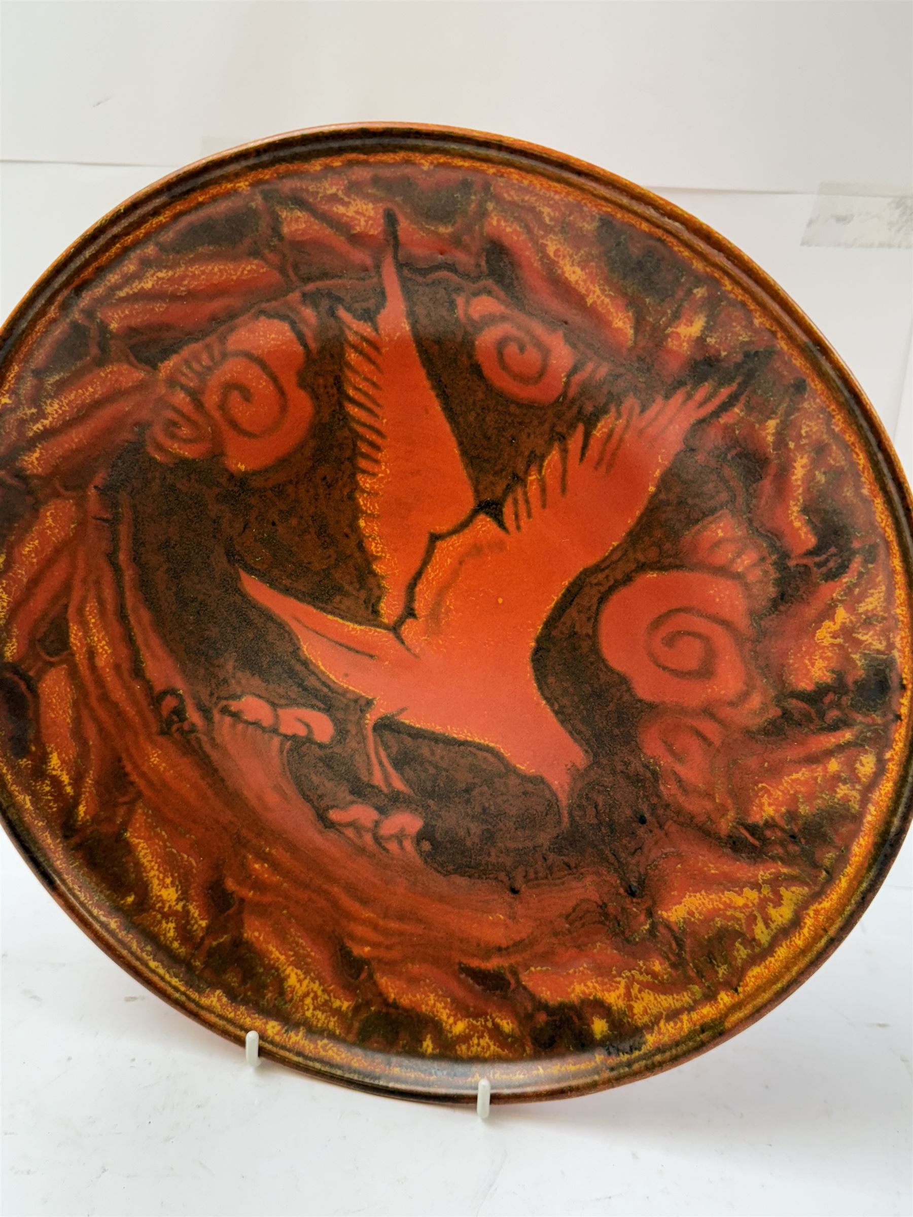 William Salter Mycock (1872-1950) for Pilkington's Royal Lancastrian, orange charger decorated with a bird in flight, D29cm