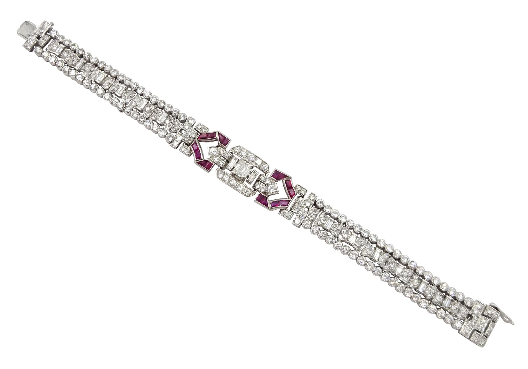 Art Deco platinum diamond and ruby bracelet, circa 1920-1930, the central panel set with a single emerald cut diamond of approx 0.55 carat, flanked by two baguette cut diamonds and old cut diamond surround, the articulated geometric design bracelet with vari-cut rubies, round and baguette cut diamonds, total diamond weight approx 7.00 carat, in Mappin & Webb silk and velvet lined box