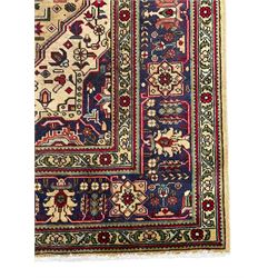 Persian Heriz pale wheat ground rug, indigo pole medallion surrounded by neatly arranged Hac and stylised flower head motifs, indigo main border decorated with alternating palmette motifs, within floral pattern guard stripes 