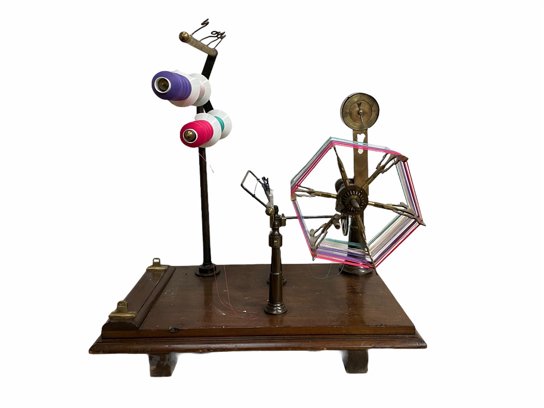 Victorian brass and cast metal wool winder by Goodbrand & Co, Manchester on a mahogany base, L70cm 