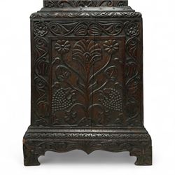 Man Beckett (I) of Stockton on Tees (Co Durham) - 8-day early 18th  century longcase clock in a  profusely carved oak case, with a caddy top, turned finials and attached barley twist pilasters to the break arch hood door, long trunk with carving and a conforming long rectangular door carved with a Celtic depiction of the tree of life, corresponding plinth with a carved and decorative base, break arch brass dial with a rounded brass surround, cast spandrels and silvered boss with the makers name to the arch, matted dial centre with seconds dial, ringed winding apertures, square date aperture and fettled steel hands, silvered chapter with Roman numerals, five minute Arabic's, half hour markers, minute and inner quarter hour tracks, dial pinned to a five pillar movement with inside countwheel striking and a recoil anchor escapement, striking the hours on a bell. With weights and pendulum.
Man Beckett (I), (first name is a biblical name short for Manasseh), was the first member of the Beckett family of prodigious clockmakers working in the North-East of England from 1720 until 1884.